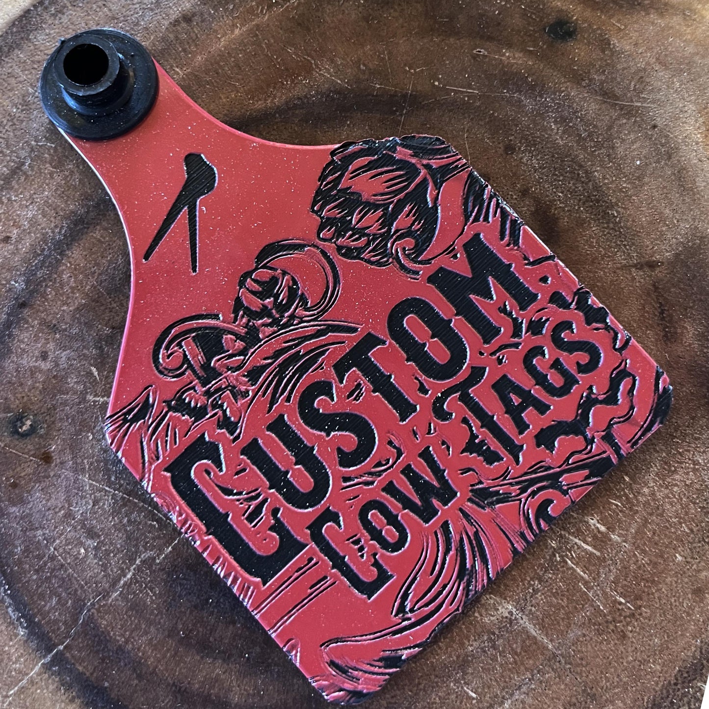 Red and black custom cowhide product on a wooden surface
